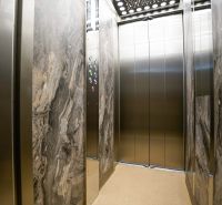 The interior of the elevator with marble walls and mirrors in a studio apartment.