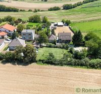 Village gardens in Pastuchov with houses surrounded by fields and meadows.
