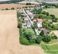 An aerial photograph captures the view of a village near a field in Záhrady, Pastuchov.