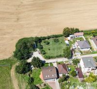 Aerial view of gardens in Pastuchov, surrounded by houses and fields.