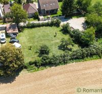 Houses with gardens in Pastuchov surrounded by fields and greenery.