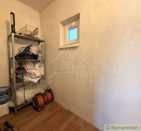 Storage rack with tools and floor with wooden decor in the cottage.