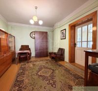 Living room in a family house with wooden furniture and a textile carpet.