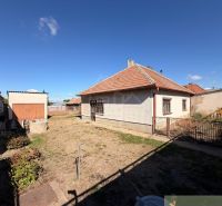 A family house in Hurbanovo with a yard, lawn, and an annex in the background.
