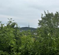 A view of the TV tower surrounded by greenery in Bratislava on Drotárska Road.