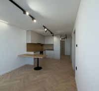 A room with a wooden decor floor, a kitchenette, and lighting, a 4-room apartment.