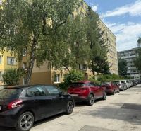 A view of Obrody Street in Košice - Západ with parked cars near a 4-room apartment.