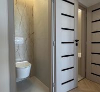 Interior of a 4-room apartment with wood-decor flooring and a toilet room.