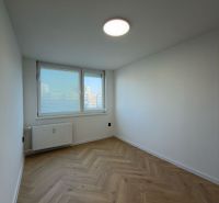 A bright room in a 4-room apartment with a wooden decor floor.