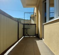 The balcony of a 3-room apartment in Trenčianske Teplice, Štvrť SNP, sunny day, simple balcony furniture.