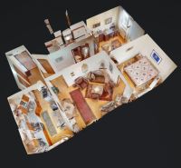 Interior design of a 3-room apartment with wood-patterned flooring and furnished with furniture.