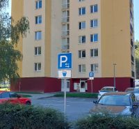 Apartment building on SNP Quarter in Trenčianske Teplice with a parking lot and greenery in the foreground.