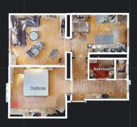 Floor plan of a 2-room apartment with furnishings and wooden decor flooring.