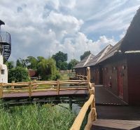A cottage by the Senec lakes with wooden elements and a tower-like structure in the garden.