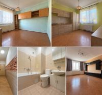 Interior of a 2-room apartment with a wooden decor floor and a light kitchen.