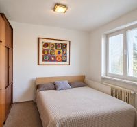 Bedroom with a double bed and a built-in wardrobe in a 3-room apartment.