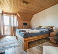 A room with wooden paneling and a floor with a wooden decor in hotels and guesthouses.