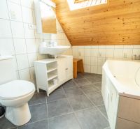 Bathroom with a bathtub, sink, and tiles in hotels and guesthouses.