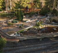 In the area near Liptovský Michal, there is a model railway surrounded by greenery.