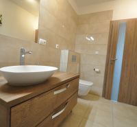 Bathroom in a 3-room apartment with a sink, wooden decor flooring, and a toilet.