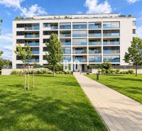 A building with modern balconies, surrounded by greenery on Malokrasňanská Street in Bratislava III.