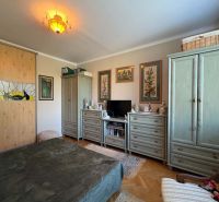 A bedroom in a 3-room apartment with decorative lighting, a wardrobe, and a dresser.