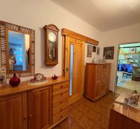 The entrance hall of a 3-room apartment with wooden decor and classic furniture.
