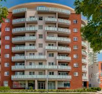 A high-rise building with interesting balconies near Bosákova Street, close to the garages in the city.