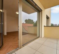 Spacious balcony with a view and access to a floor with wooden decor in a 3-room apartment.