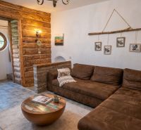 Living room in a family house with rustic elements and a comfortable sofa.