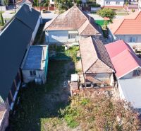 A family house in Kráľov Brod with yards, roofs, and vegetation, surrounded by other houses.