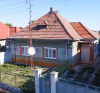A family house in Kráľov Brod with a red sloped roof and a landscaped garden.