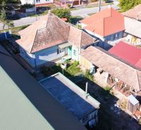 A family house in Kráľov Brod with traditional roofs and a yard in the surrounding development.