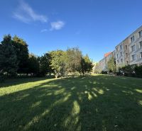 The park on Ďumbierska Street in Nitra is lined with trees and residential buildings.