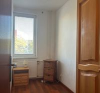 A small room in a 2-room apartment with a floor featuring a wooden decor.