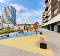 Playground with benches at Muchovo Square in Bratislava, in front of a 2-room apartment.