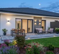 A family house in Hôrka nad Váhom with a terrace, lighting, and a garden during the evening.