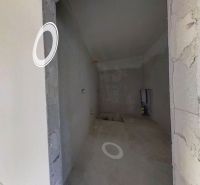 Interior of a family house with plastered walls and built-in openings for installations.