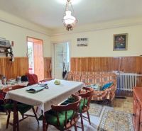 Living room in a family house with a dining table and a display cabinet.