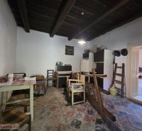 A family house with a rustic interior, wooden ceiling, and colorful tiles.