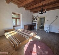 A bedroom in a family house with a bed and a wooden decor floor.