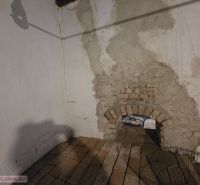 Peeling plaster and brick vault in the interior of a family house.