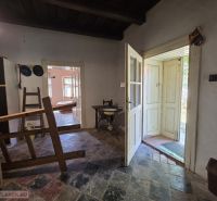 The interior of a family house with a tiled floor and wooden furniture.