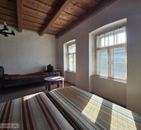 A room in a family house with wooden ceilings and natural light.