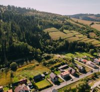 Aerial view of residential plots in Čierny Balog, Švermova, with surrounding forest.