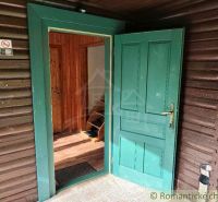 Entrance to a wooden cabin in Rajecká Lesná with open doors and a wooden decor floor.
