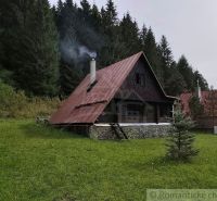 A cottage in Rajecká Lesná with a metal roof and a garden in the middle of the forest.