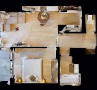 Floor plan of a 2-room apartment with wood-patterned flooring, top view.