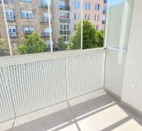 A balcony with a view of the street in a 2-room apartment with modern railings.