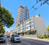 Šancová Street in Bratislava - Staré Mesto with a modern high-rise building and greenery.